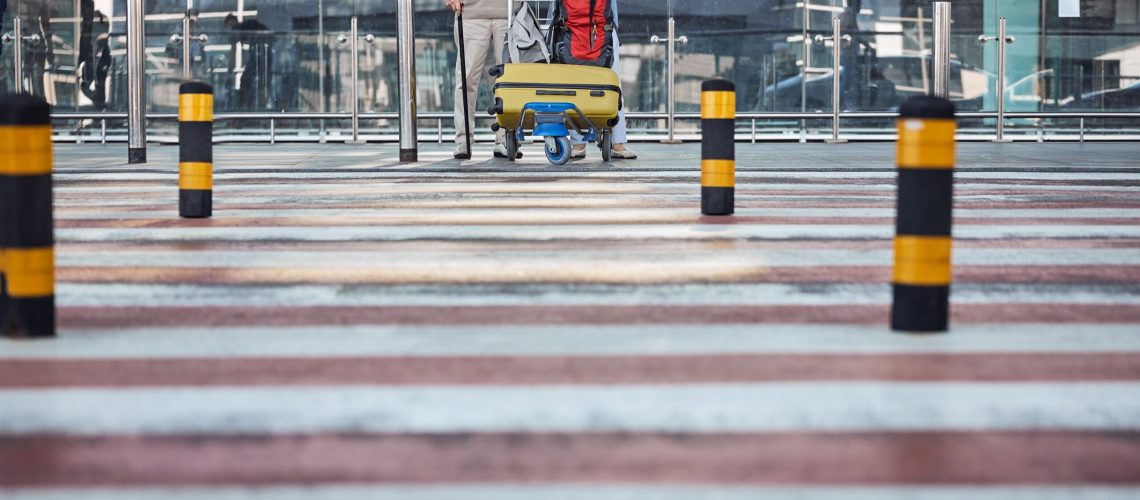 senior-couple-outside-the-airport-terminal-buildin-2023-11-27-05-16-29-utc (1)